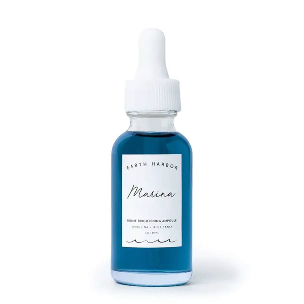 earth harbor marina biome brightening face serum in a travel sized glass dropper bottle