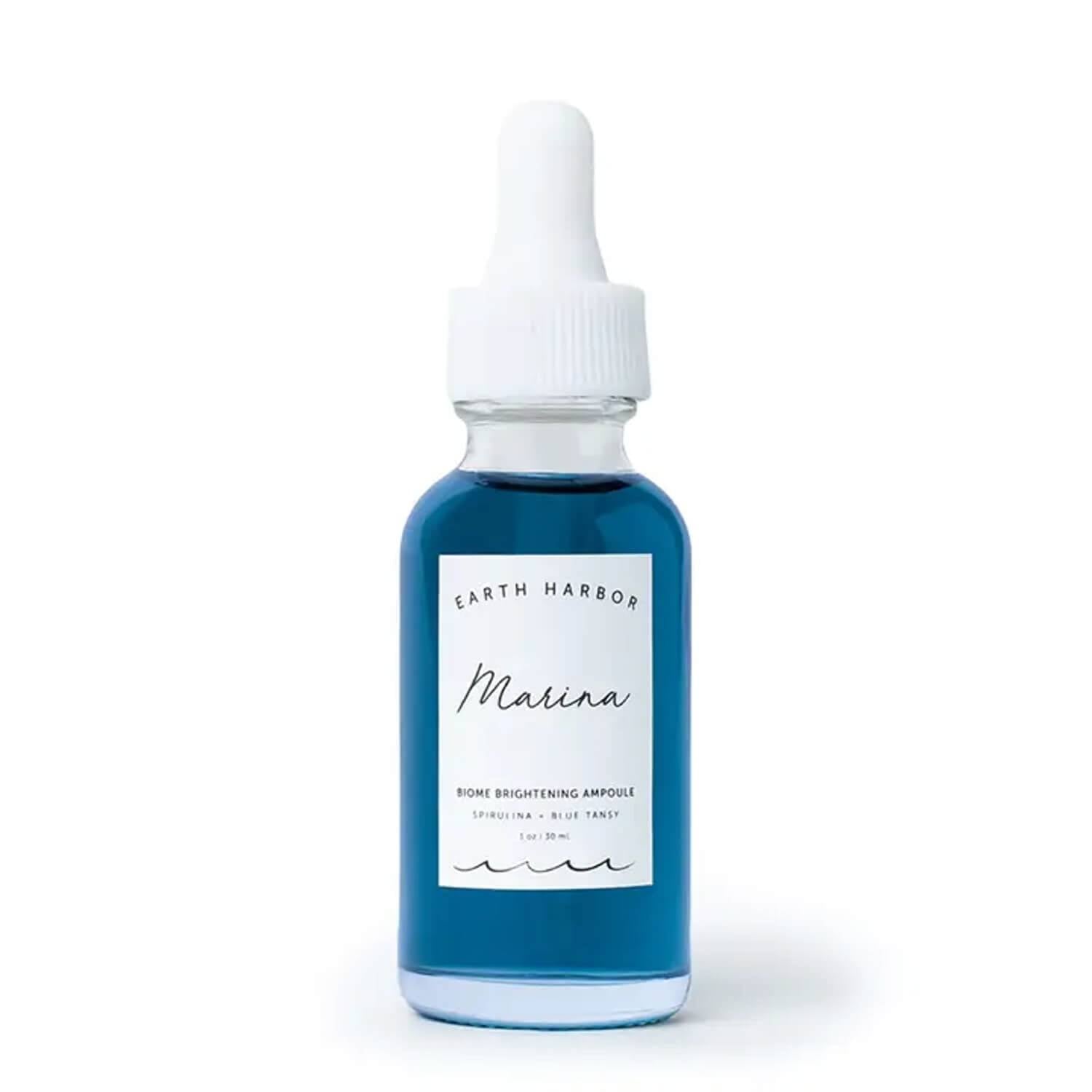 earth harbor marina biome brightening face serum in a travel sized glass dropper bottle