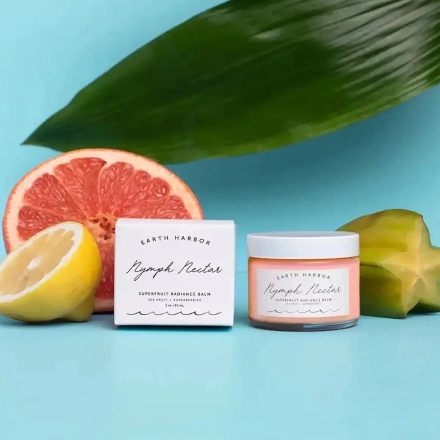 earth harbor nymph nectar super fruit radiance facial balm next to a grapefruit