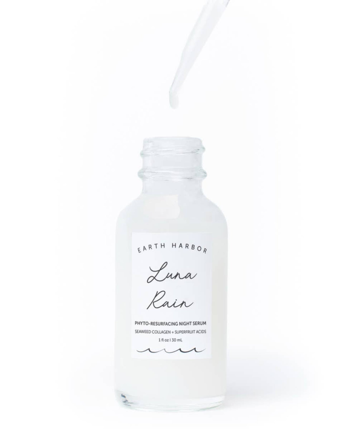 a bottle of earth harbor luna rain sitting on a white surface