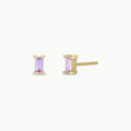 Gold stud earrings with pastel purple baguette stones on a white background