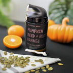 a bottle of essential oil body lotion with blood orange, pumpkin seed & jojoba oil by bohemian reves next to ingredients