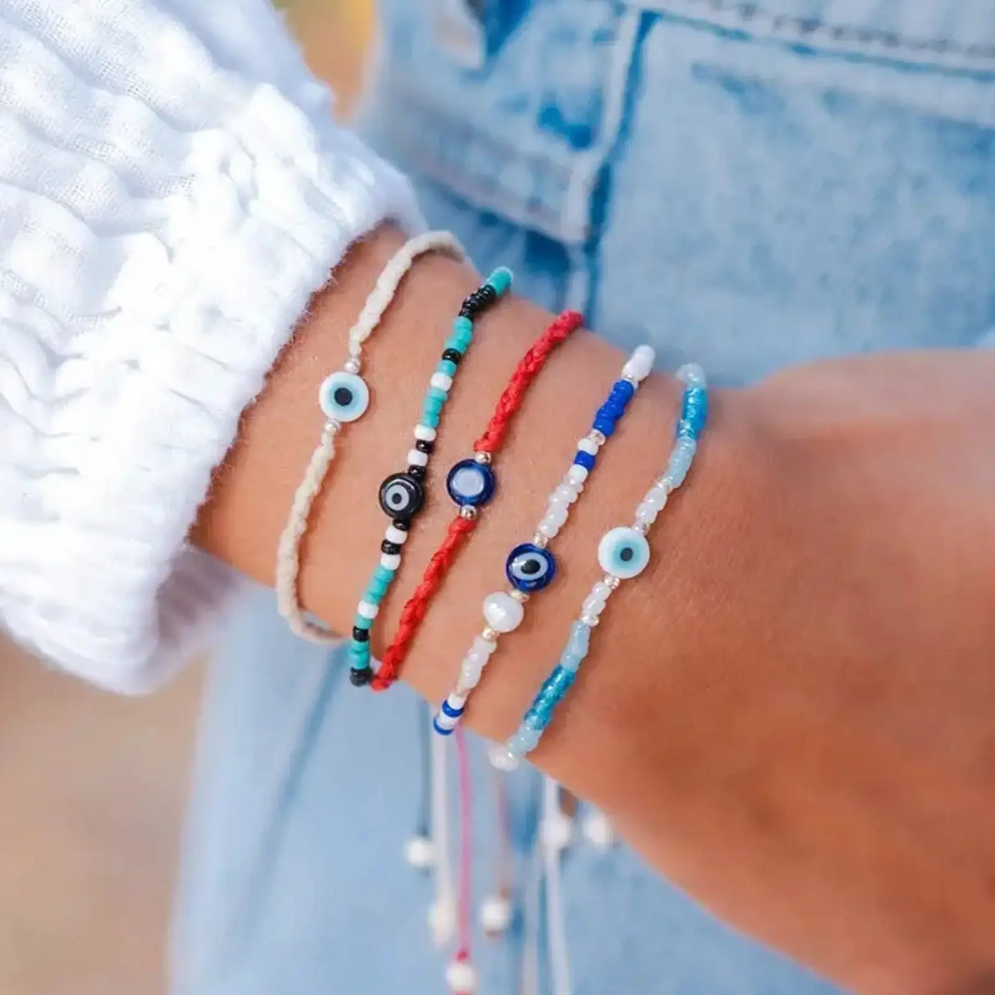 evil eye bracelets shown on a wrist by lotus and luna