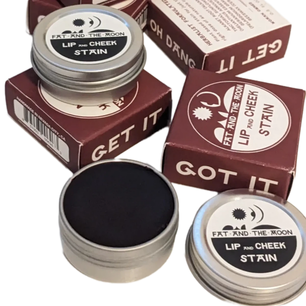 Fat and the Moon Lip and Cheek Stain in reusable aluminum tin shown next to its box - Photo by Elle and Willow