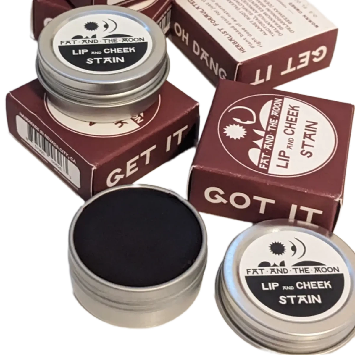 Fat and the Moon Lip and Cheek Stain in reusable aluminum tin shown next to its box - Photo by Elle and Willow