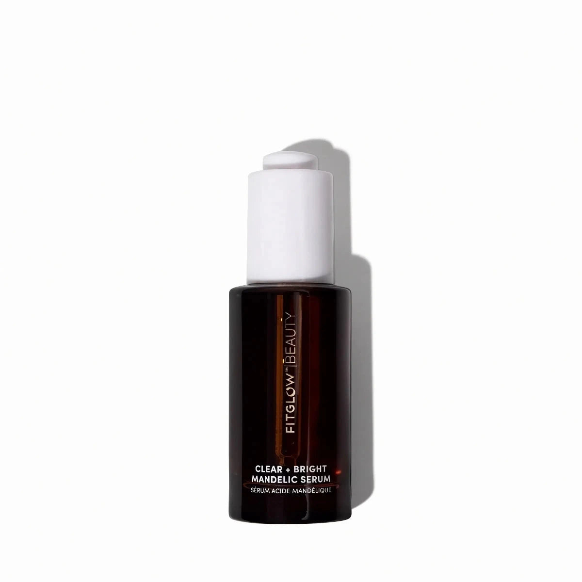 A bottle of FITGLOW BEAUTY Clear + Bright Mandelic Serum on a clean white background with a soft shadow.