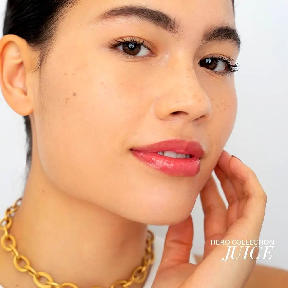 Fitglow Beauty Lip Colour Serum in Juice, a sheer cherry red color with shimmer applied to a medium skin tone model