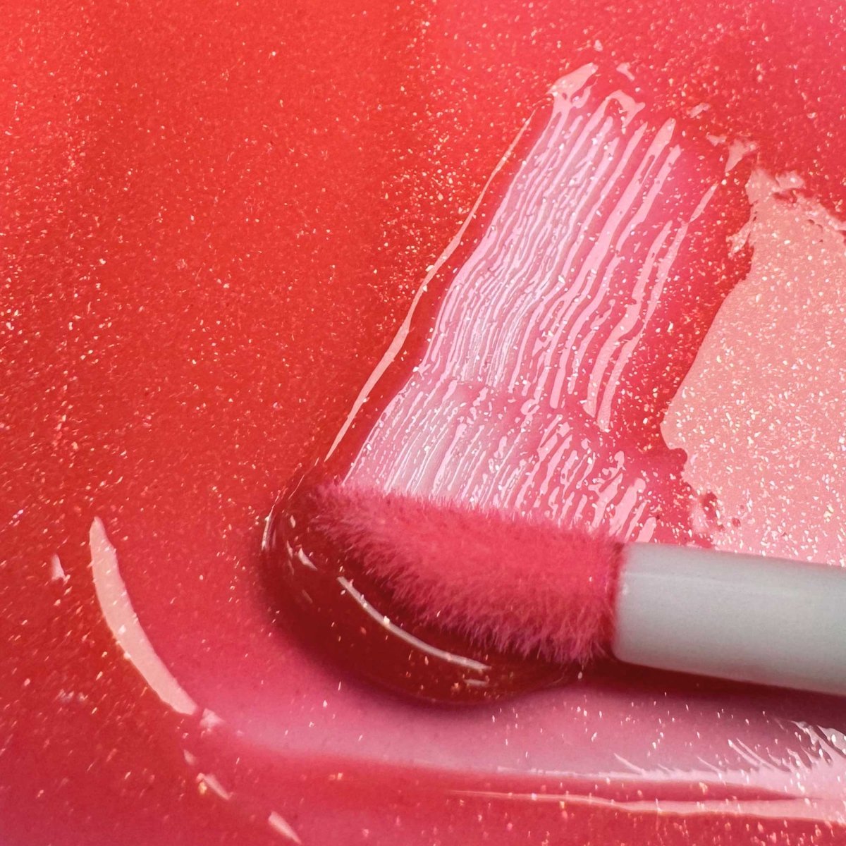 A swatch of Lip Colour Serum in 'Juice' a Shimmering Sheer Cherry Red by Fitglow Beauty shop Lip Serum at Elle and Willow