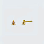 Gold stud earrings with pink champagne gemstones on a light gray background