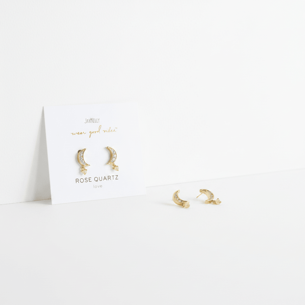Gold earrings on a white card with 'Rose Quartz' text on a white background