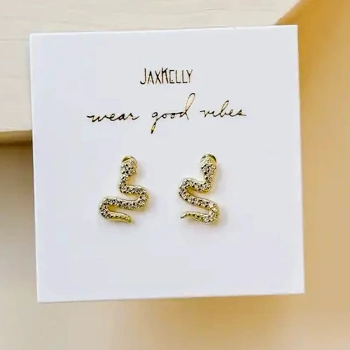 gold pave snake earrings on jewelry card - jaxkelly