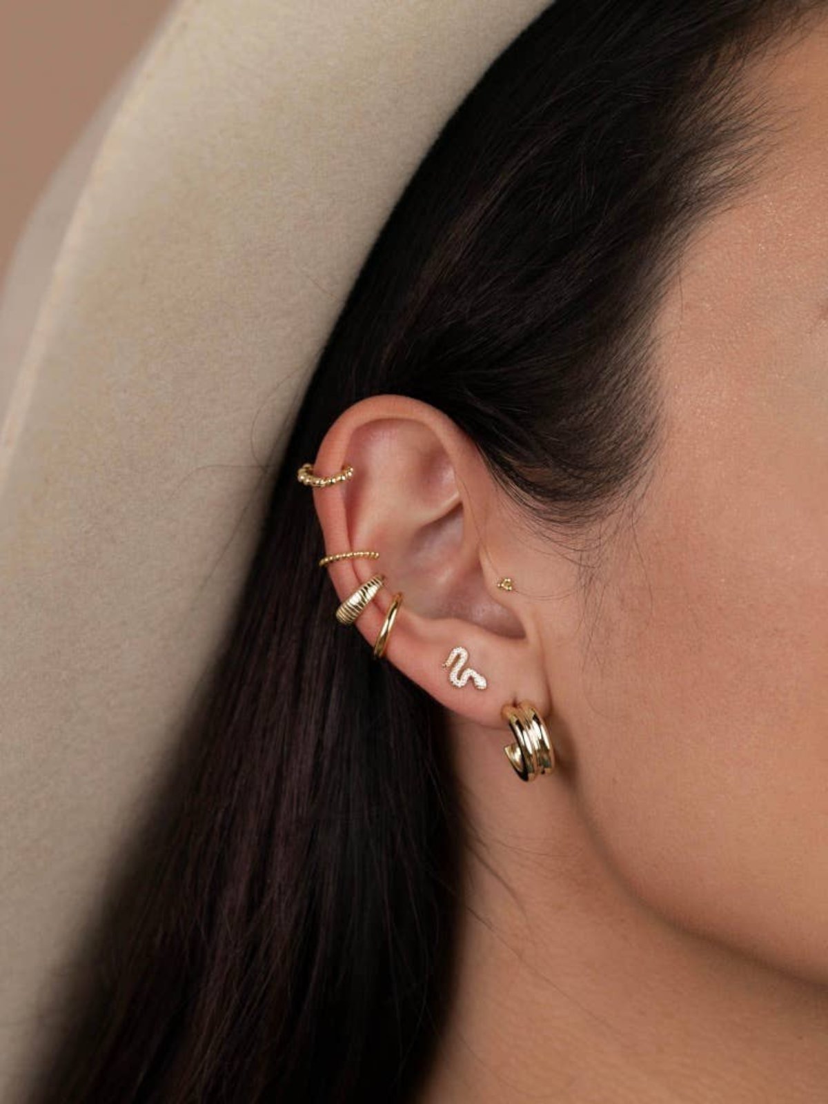 a close up of a person wearing a hat and JaxKelly Earrings 