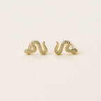 a pair of yellow gold snake earrings with simulated diamonds
