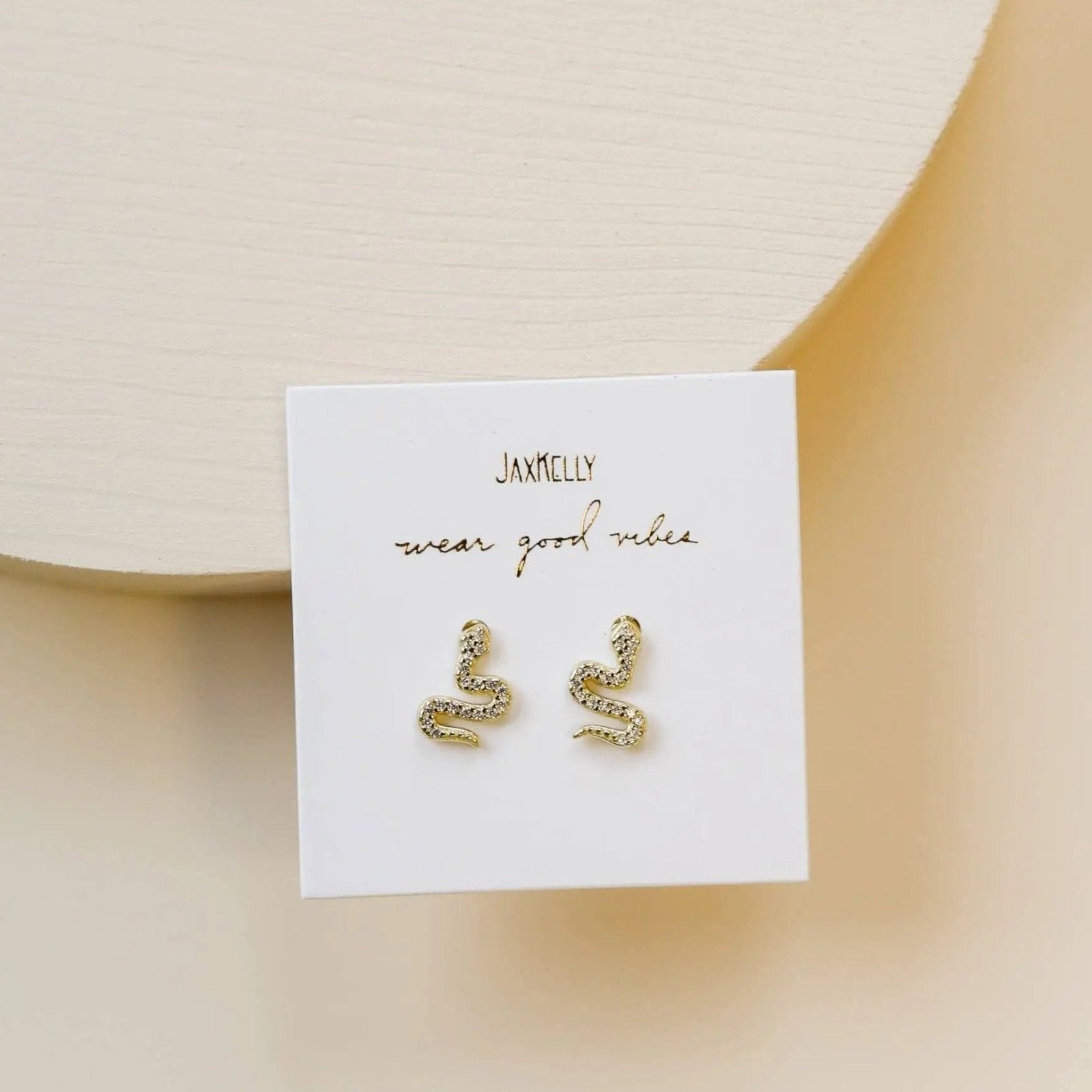 a pair of earrings sitting on top of a card