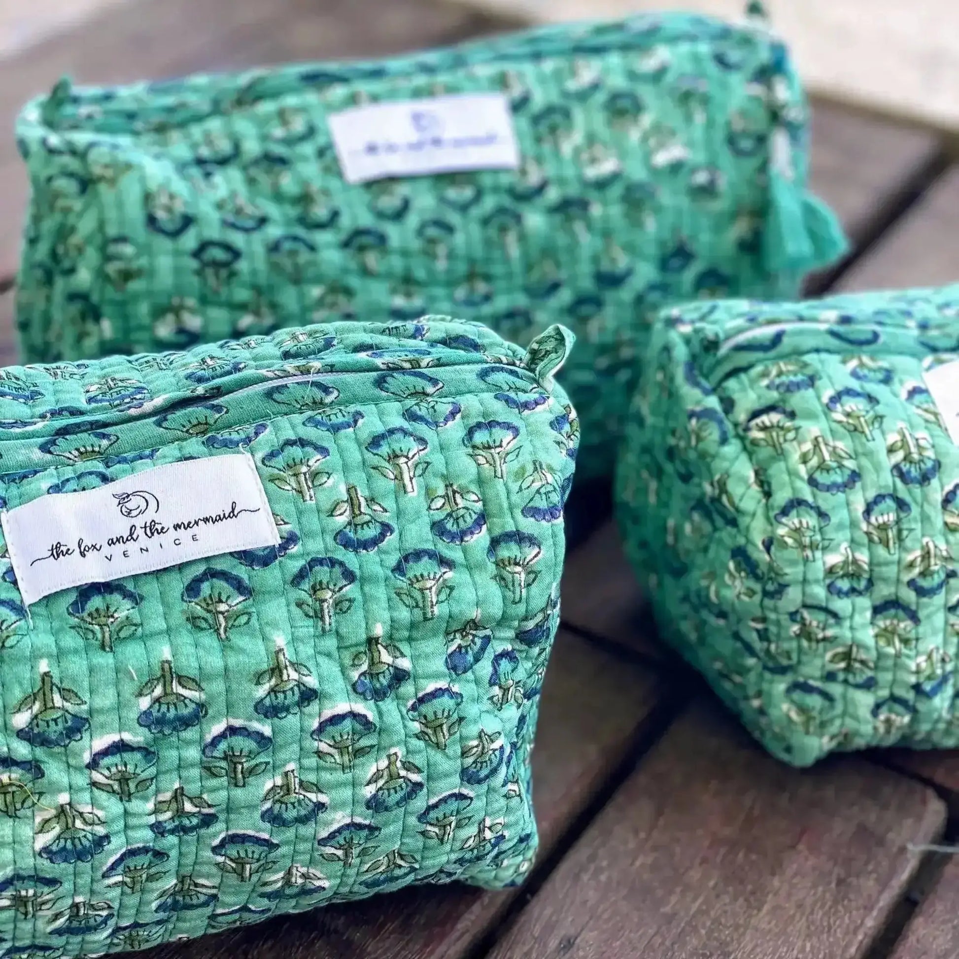 set of three varied size green floral quilted cotton toiletry bags