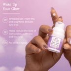 Woman holding Aura Glow Brightening Eye Cream highlighting benefits like reducing puffiness, dark circles, and fine lines.