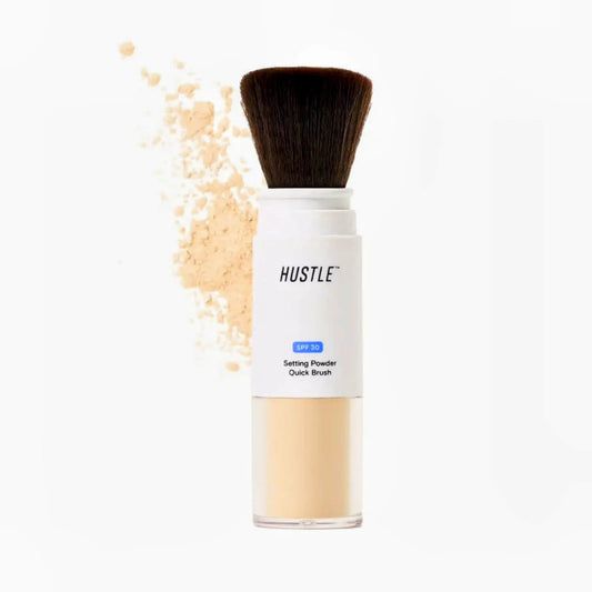 Setting powder quick brush by hustle Beauty with visible powder on a white background