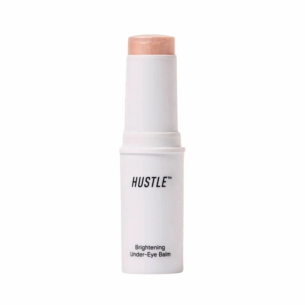 brightening under-eye balm stick by hustle beauty on a white background