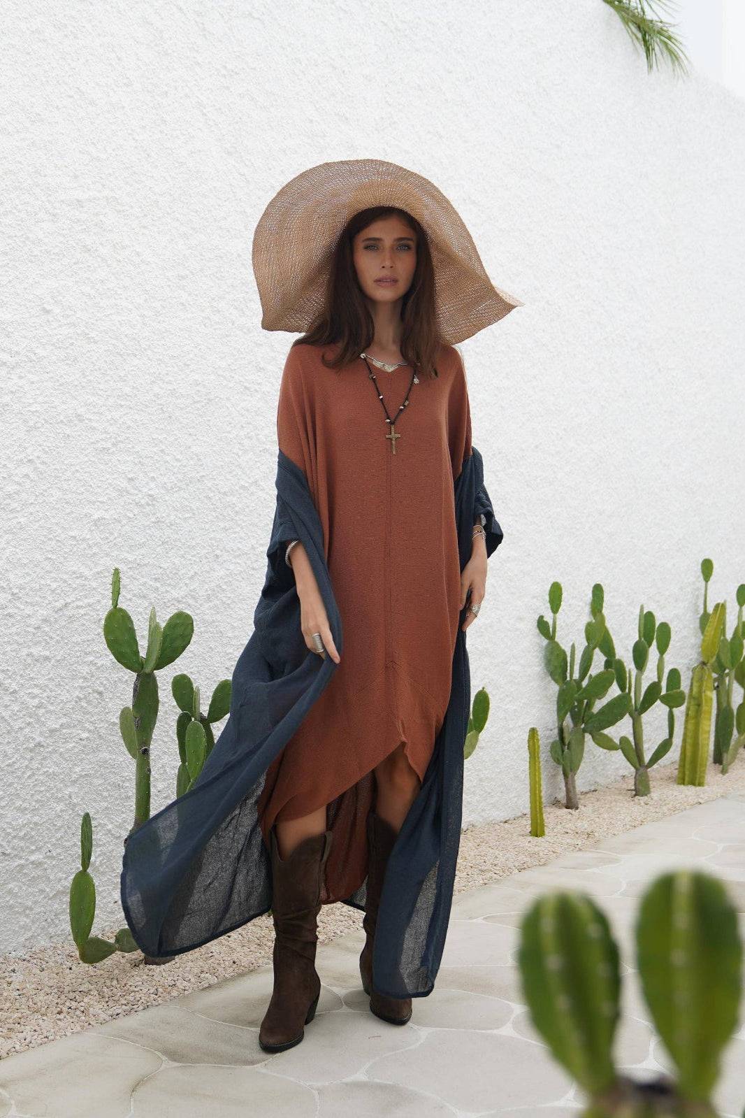 Indigo Blue Long Kimono Duster in lightweight ramie cotton draped over a rust dress, styled with a wide sun hat and boots for a boho-chic look. Ideal for layering in warm weather with breathable three-quarter sleeves and included macrame belt.