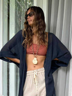 Indigo Blue Long Kimono Duster in lightweight ramie cotton styled over a rust bralette and beige drawstring pants. Features a relaxed boho fit.