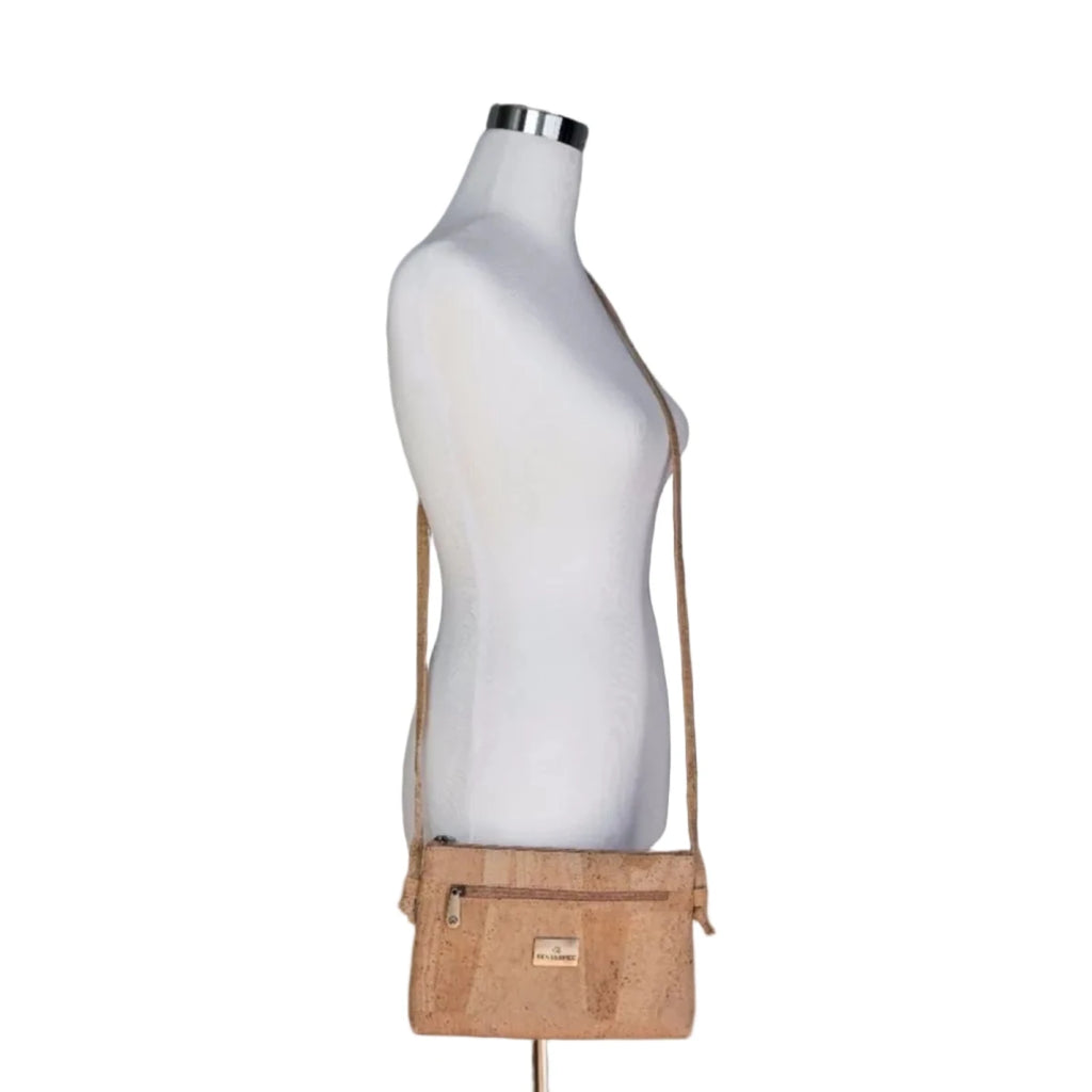 Cork crossbody bag on a mannequin against a white background, minimalist accessory trends at Elle and Willow