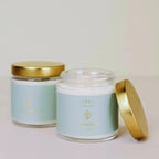 two jars of jaxKelly crystal candles sitting on a table
