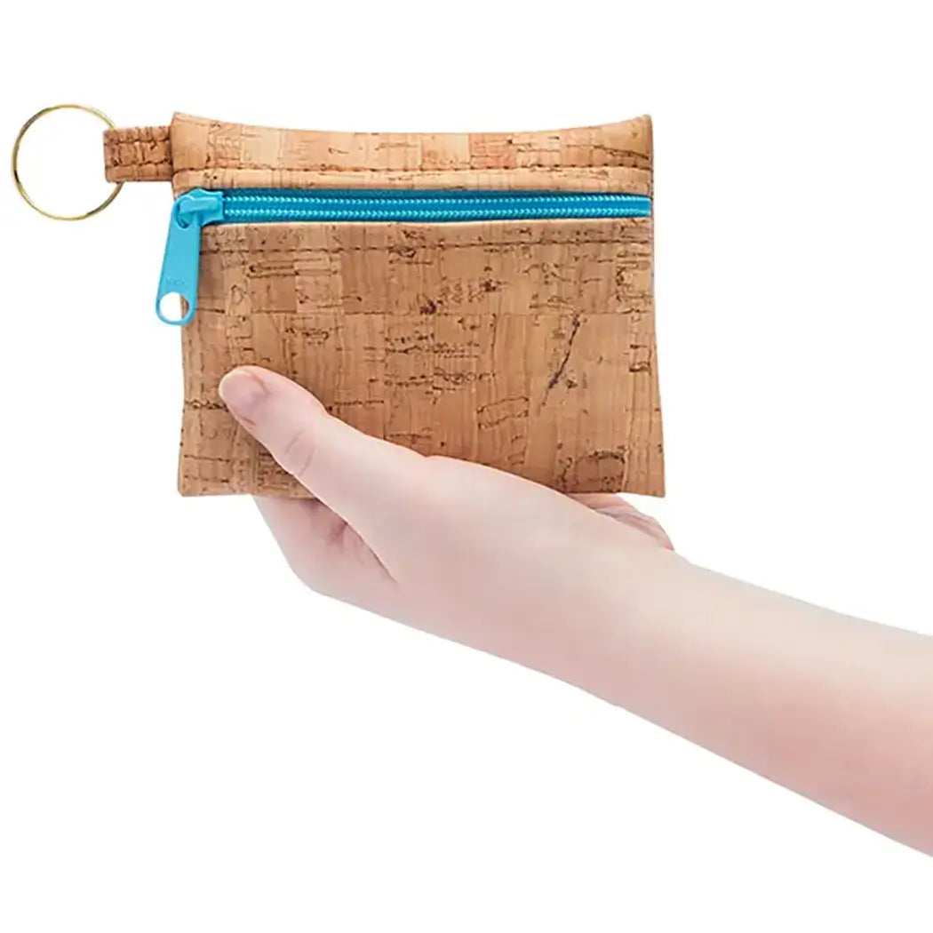 Keychain pouch in tan cork with blue zipper.