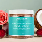 Jar of Laguna Herbals Rose Crush scrub with roses and a coconut on a light background