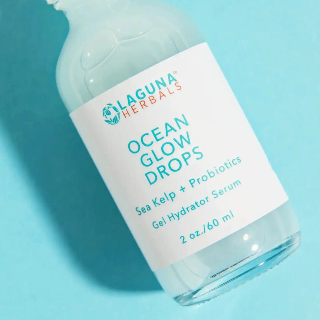 Bottle of Laguna Herbals Ocean Glow Drops Probiotic Face Serum on a blue background
