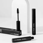 Two tubes of black Lashfood Mascara on display showcasing the extra-large lengthening, and defining bristle brush.