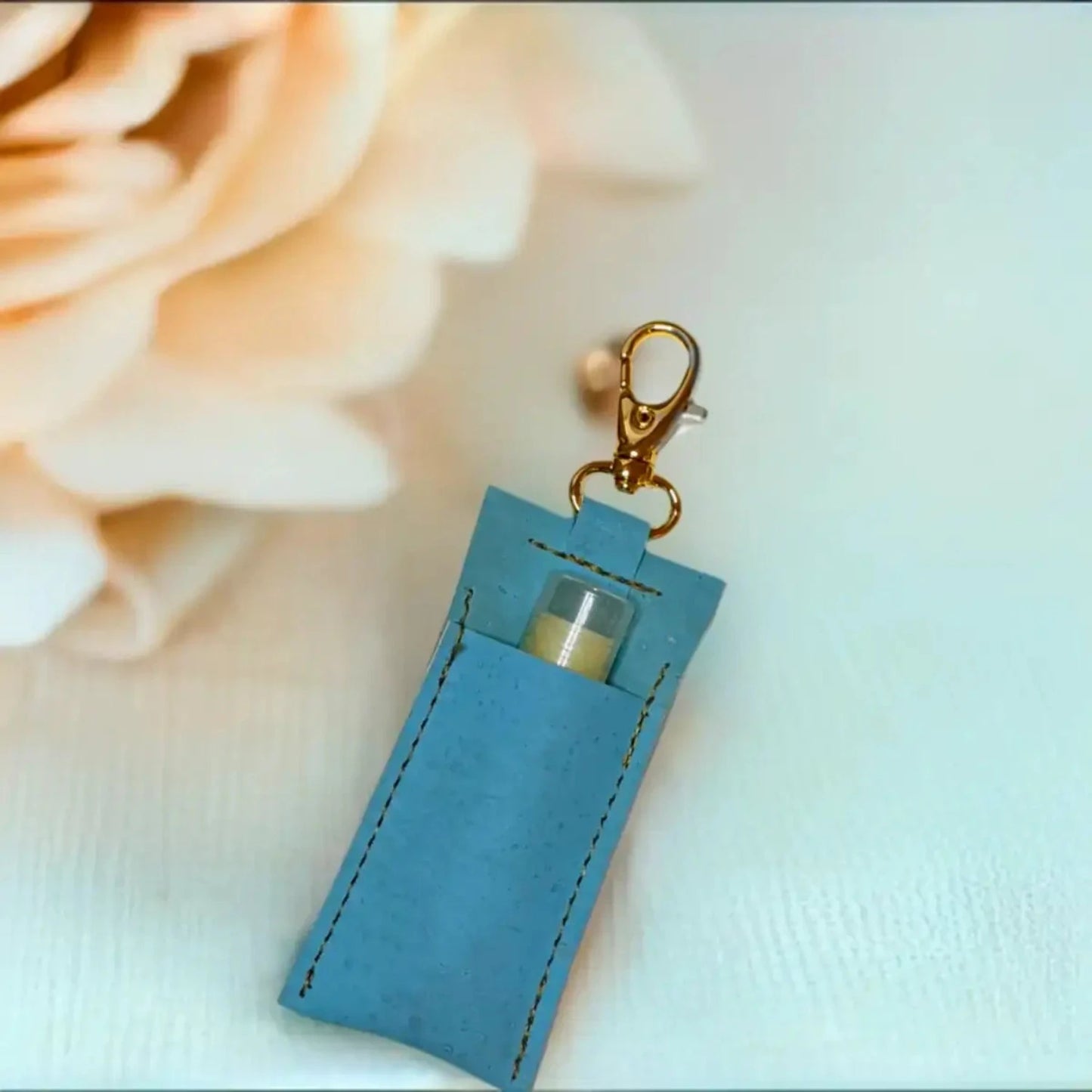 blue lip balm holder with gold color key ring