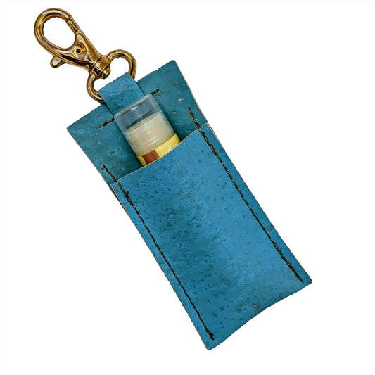 a blue lip balm holder with gold keychain attached
