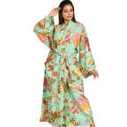 Women wearing a long kimono robe with long kimono style sleeves, front tie fabric belt and two front pockets.