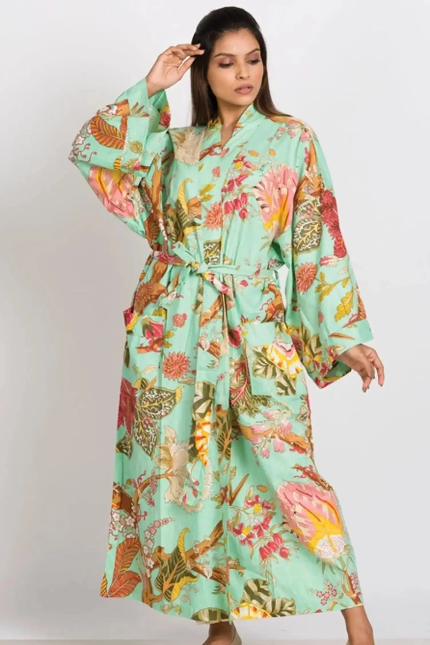 woman wearing a long green floral kimono robe