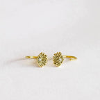 Pair of yellow gold lotus flower huggie style earrings with a small white round Cubic Zirconia center stone.