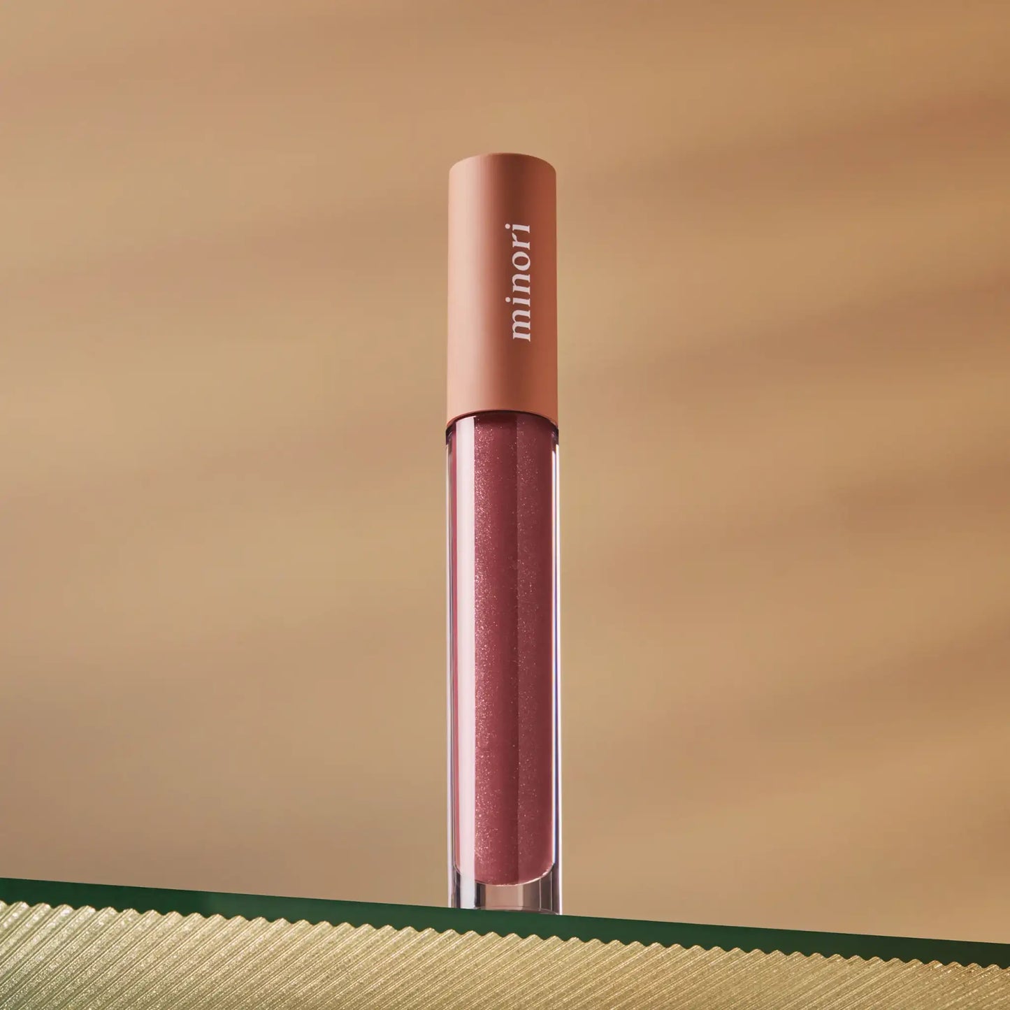 a tube of minori lip gloss in juneberry