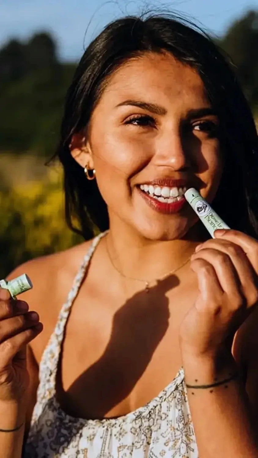 woman using blue heron botanicals mint lip balm