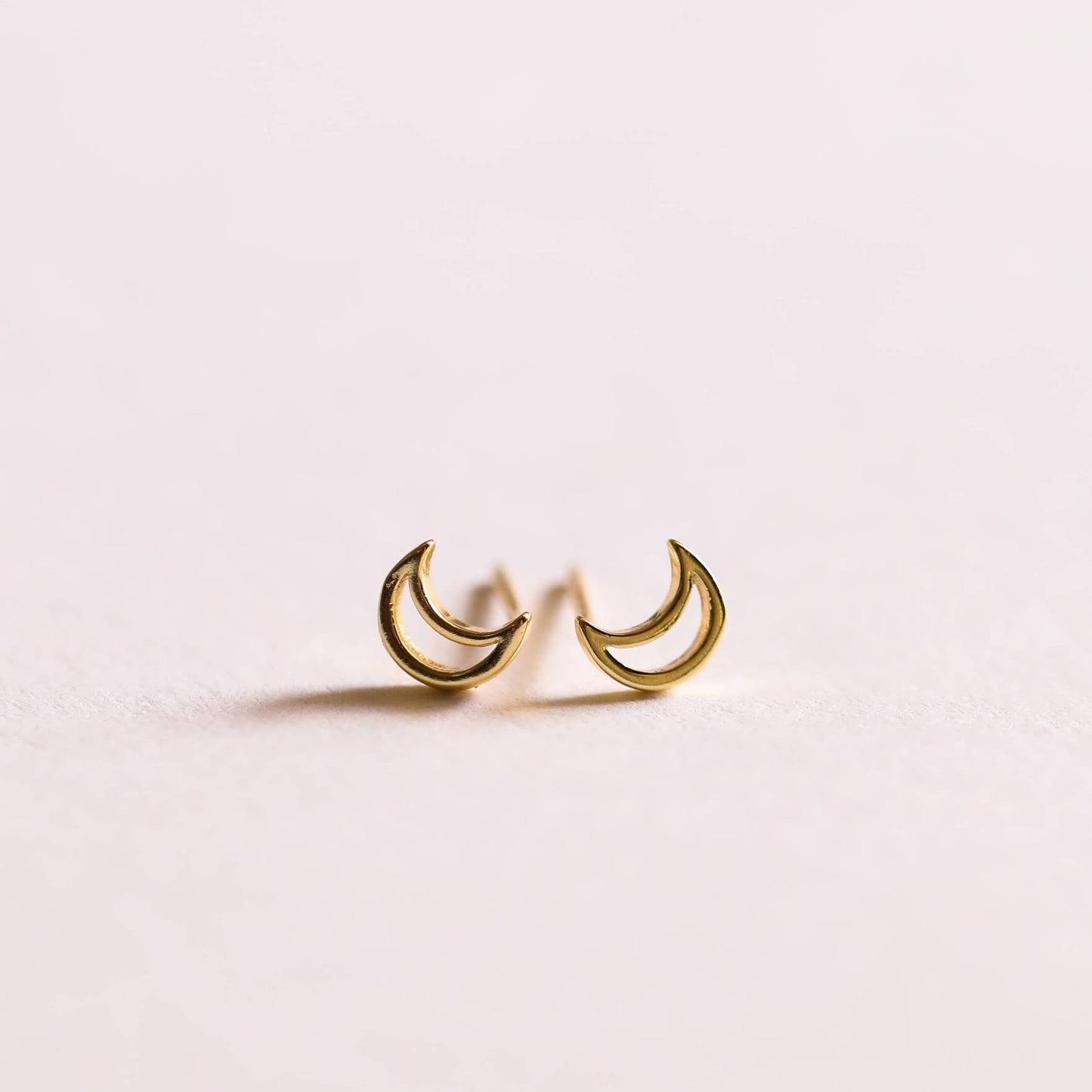 a pair of gold moon stud earrings by JaxKelly 