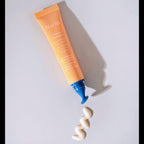 nuria beauty defend triple action eye cream mini tube with contoured eye applicator tip.