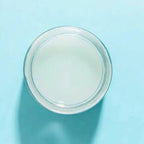 a glass jar of Laguna Herbals Ocean Jelly Mask a blue background showing the gel textured formula.