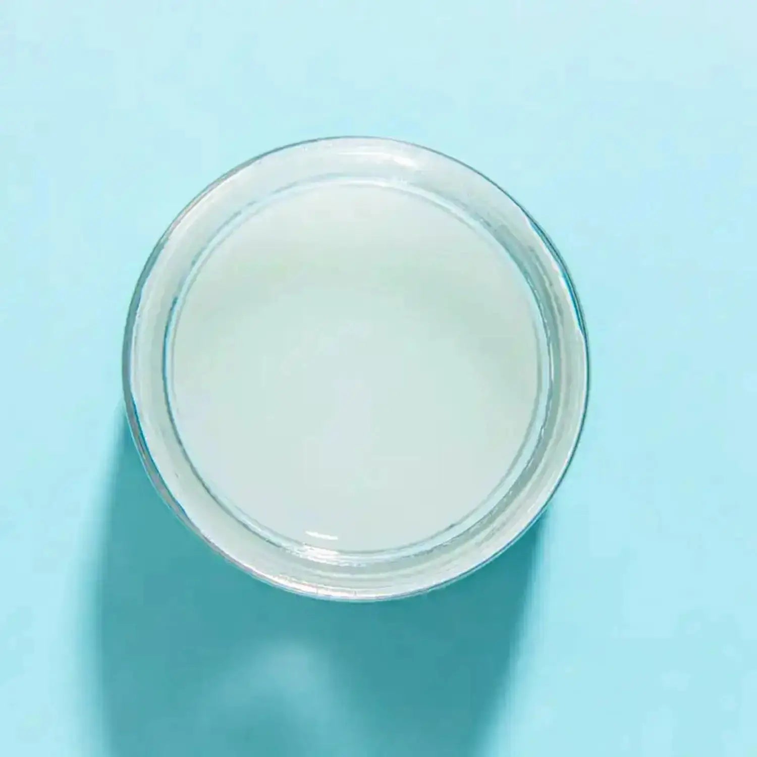 a glass jar of Laguna Herbals Ocean Jelly Maskon a blue background