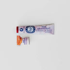 red tinted lip balm and lip stain with grapefruit oil in a paper eco-friendly tube from blue heron botanicals