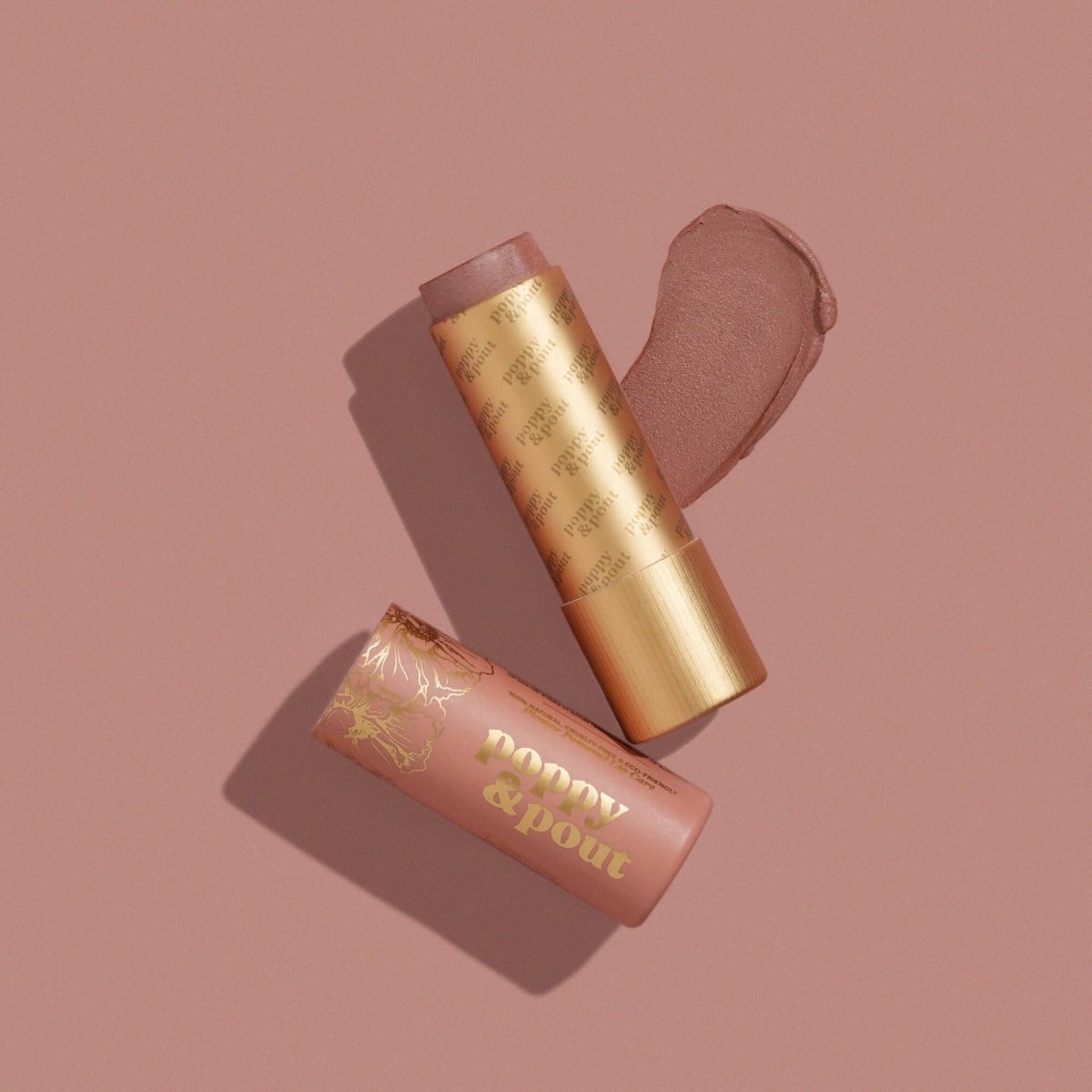 Close up texture shot of Poppy and Pout Charlie natural nude lip tint balm in its eco-friendly paper tube.