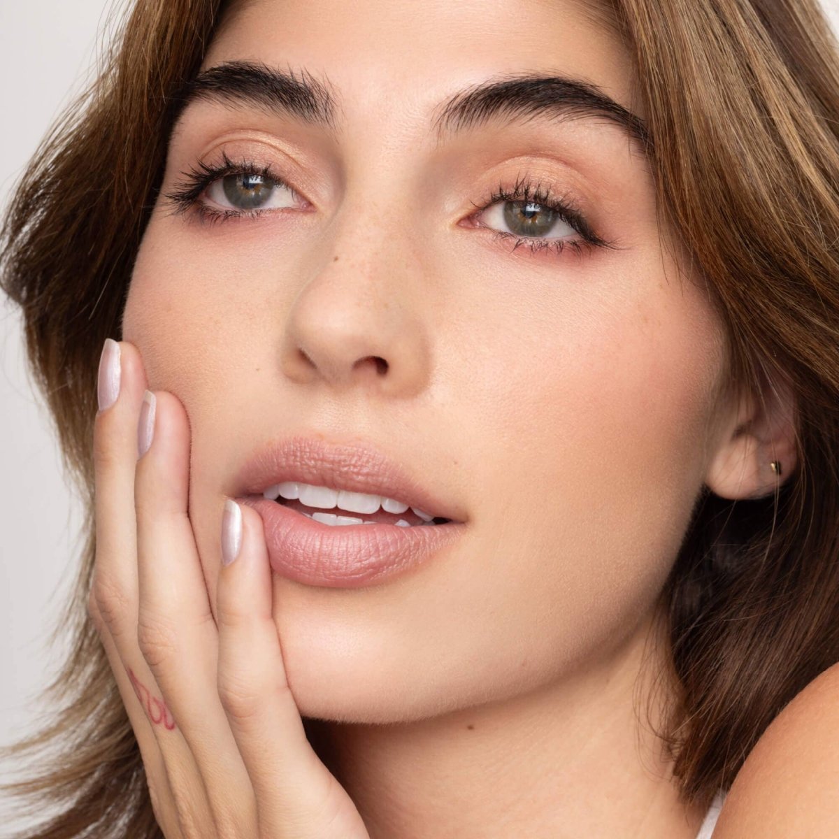 Poppy and Pout Charlie lip tint applied on lips demonstrating a natural everyday cool nude lip tint finish on a model