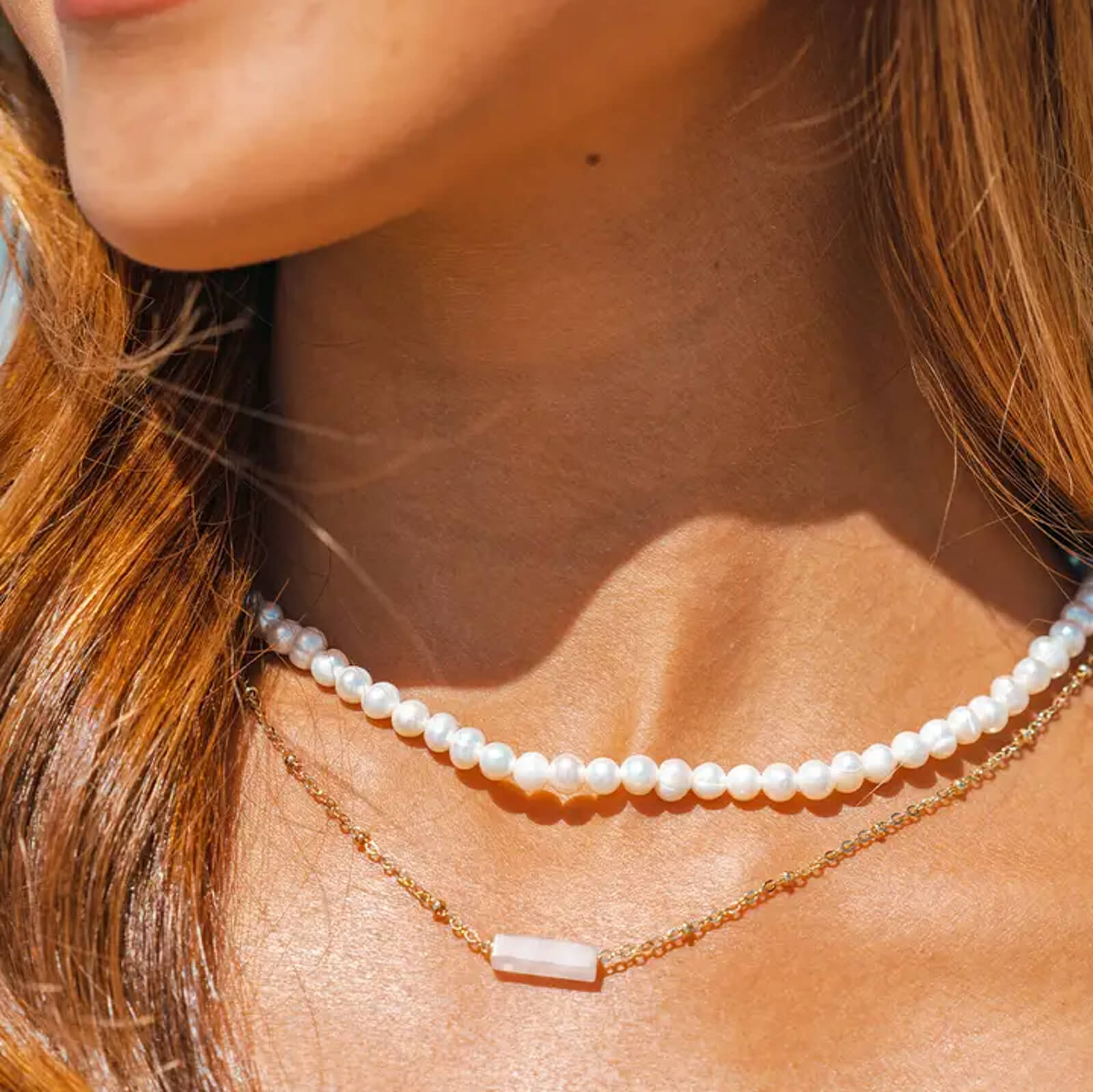 woman wearing a raw rose quartz gold necklace