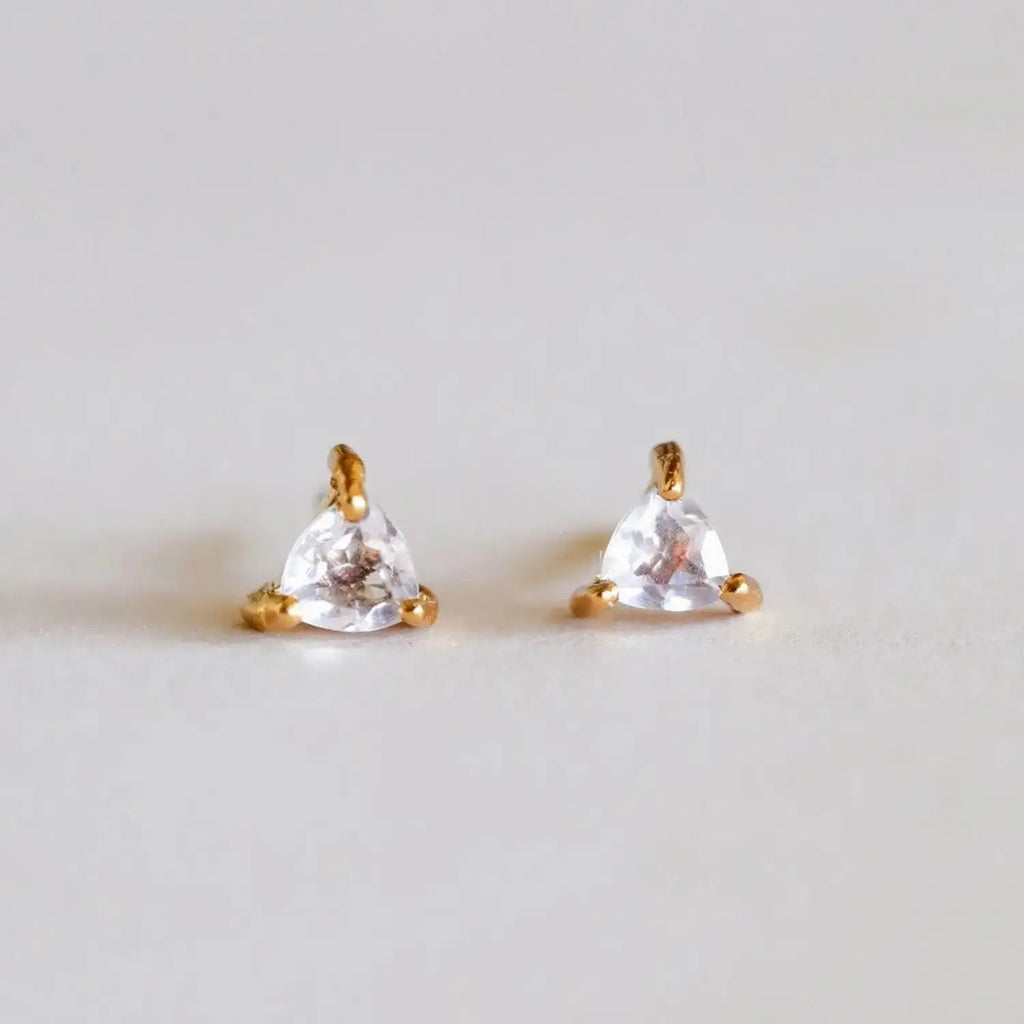 Rose Quartz earrings featuring triangular gemstone studs set in 18k gold plating. Elegant and symbolic of love, perfect for gifts or personal style.