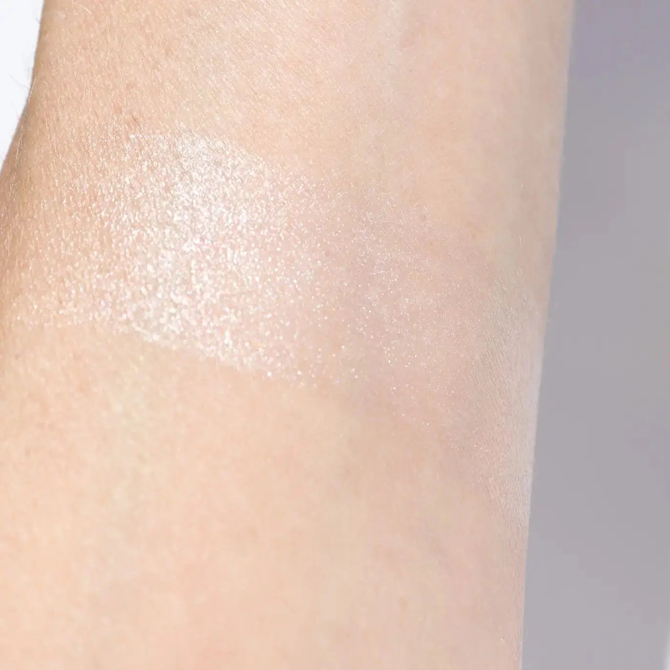 rose quartz pink cream highlighter on fair skin