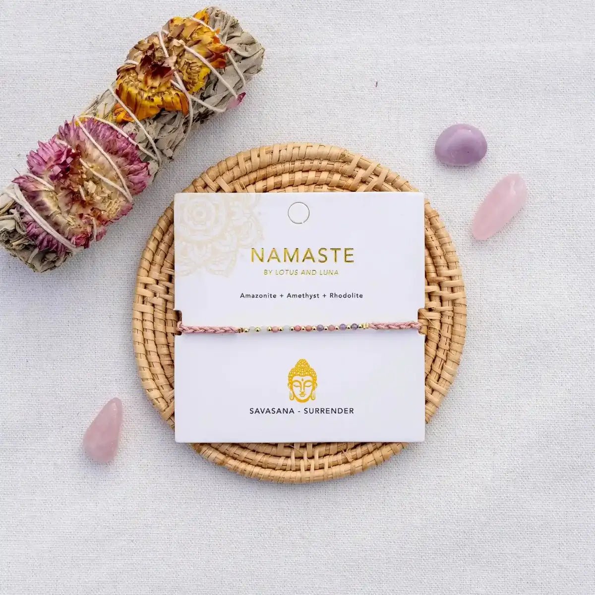 Savasana Namaste Yoga Bracelet on Lotus and Luna Jewelry Card with Buddha Illustration surrounded by raw gemstones and a sage stick.