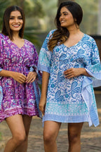 Two women in boho caftans, one in Sky Blue Paisley Caftan and the other in purple, highlighting versatile and casual style.