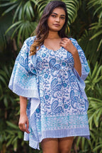 Curvy model wearing Sky Blue Caftan with turquoise paisley design, showcasing its relaxed fit and bohemian appeal.